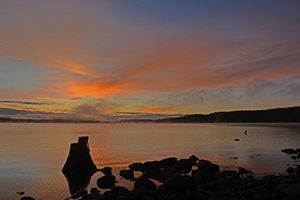 Landscape photograph of Fir Grove Campground ocean view at sunset over Campbell Lake on Vancouver Island.